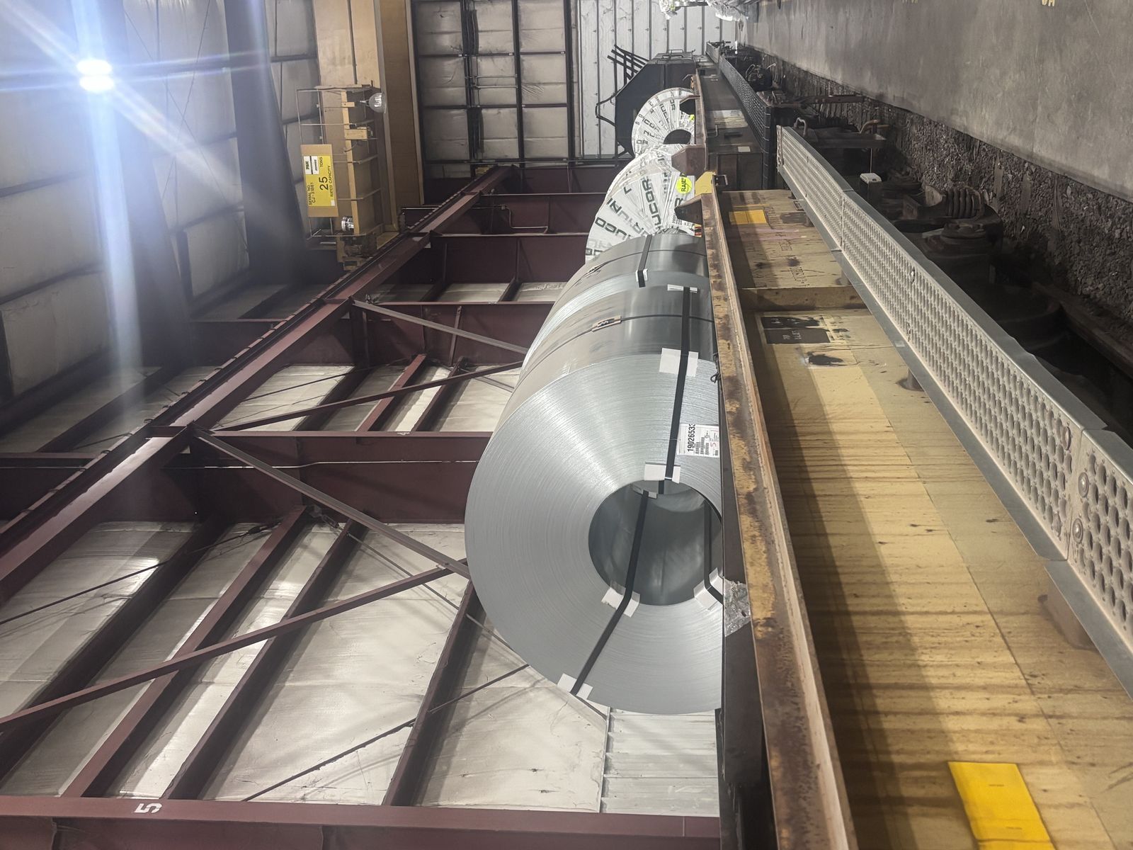 Master coils staged on a rail-served line inside Metal Master's warehouse