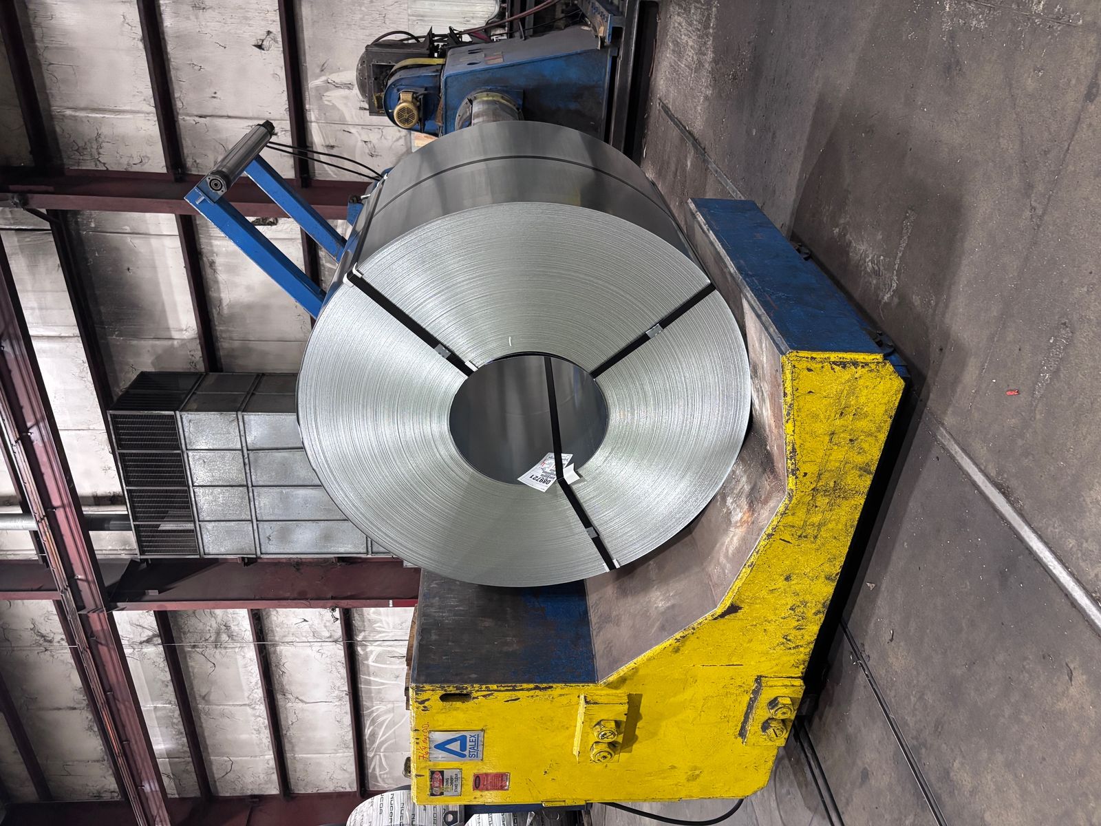 Processing cradle — master coil staged for controlled payoff at the line.
