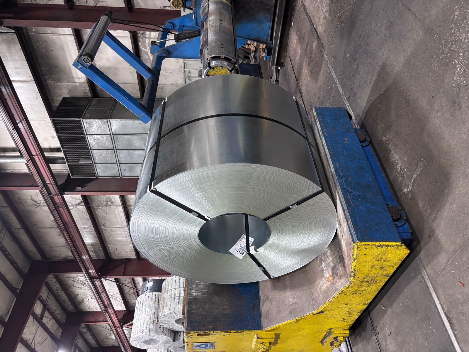Coil staged at the processing cradle — real floor photography from the facility.